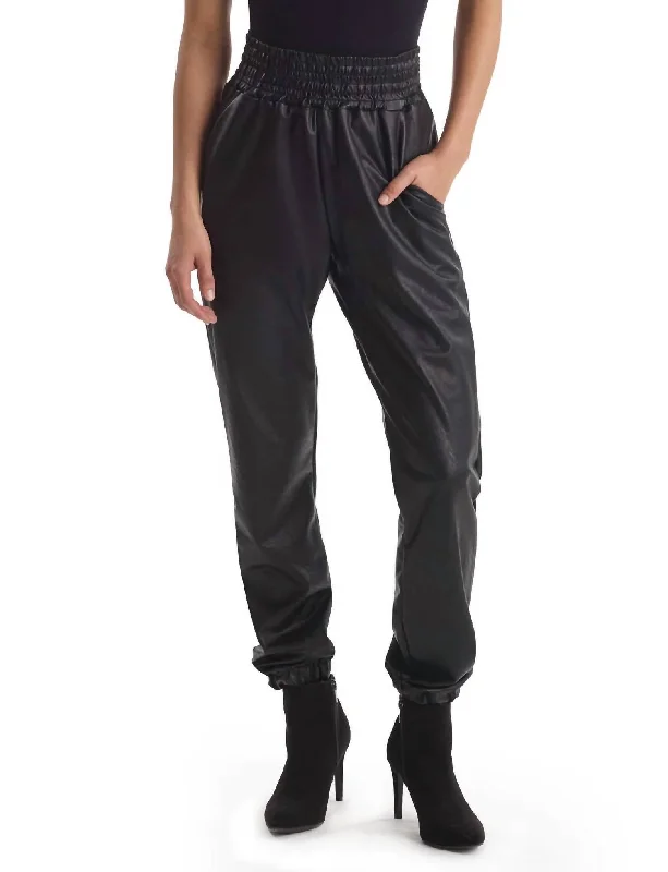 Ruffled pants for women with a feminine lookFaux Leather Smocked Jogger In Black